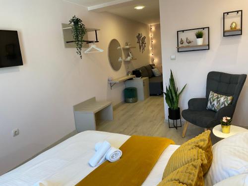 a bedroom with a bed and a living room at Guest Rooms Tsarevets in Veliko Tŭrnovo