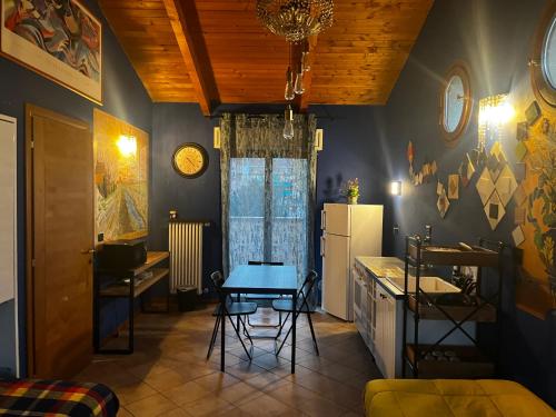 a kitchen with a table and a refrigerator at Yellow House in Turin