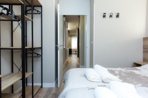 a bedroom with a bed with white pillows at Apartamento BOSTON - Centro, Nuevo, Confort, Wifi in Valladolid