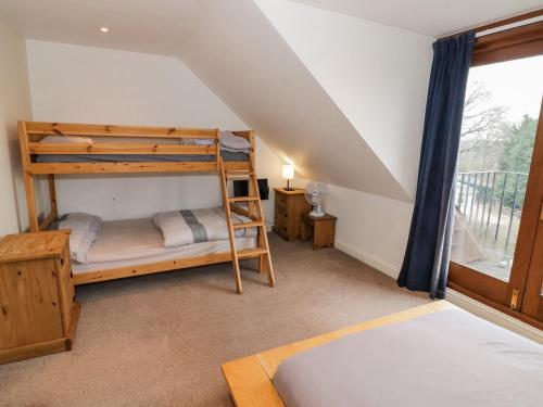 a bedroom with two bunk beds and a window at Shatterford Lakes in Bewdley