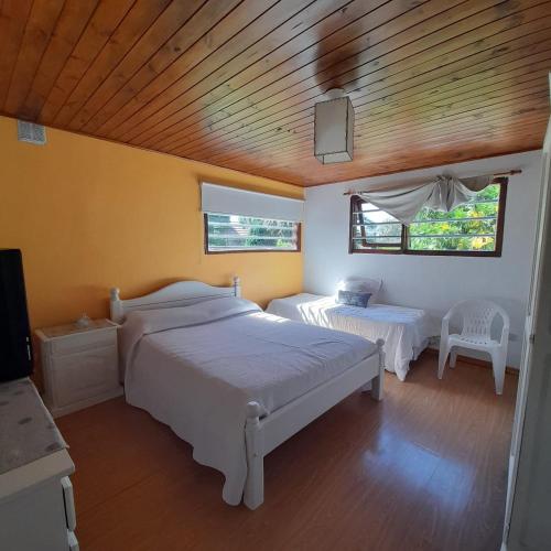 een slaapkamer met 2 bedden en een houten plafond bij Increíble casa a 4 cuadras del mar in Mar del Plata