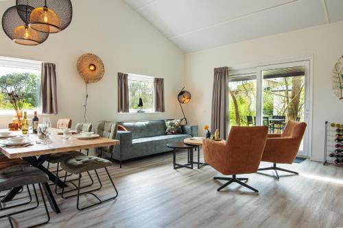 a living room with a table and a couch at Nesserduinen in Nes