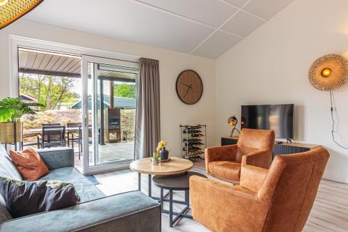a living room with a couch and a table at Nesserduinen in Nes