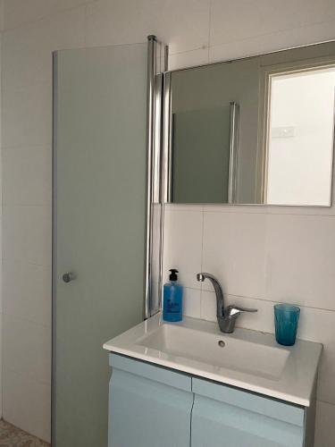 a bathroom with a sink and a mirror at Sea You Soon! in Netanya