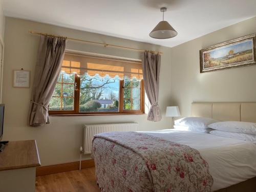 a bedroom with a bed and a window at Millhouse B&B in Ballymote