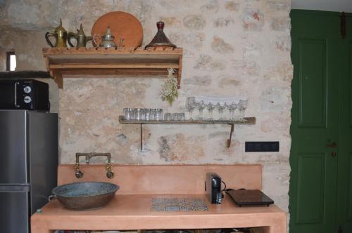 a kitchen with a bowl on top of a counter at Casa Muse Kastellorizo Whole House in Meyisti