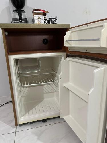 a white refrigerator with its door open in a kitchen at Nice Place in Medellín