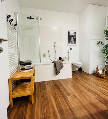 a bathroom with a shower and a toilet and a table at Apartment Leo6 in Salzburg