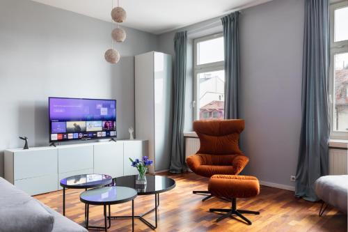 a living room with a couch and a tv at Rainbow Apartments 1 in Krakow