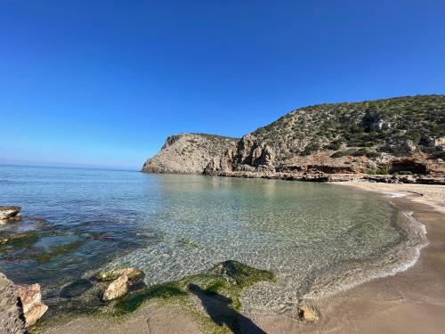 a beach with clear water and a rocky coastline at Guest House Bellavista Nebida in Nebida