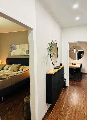 a bedroom with a bed and a mirror at Apartment Leo6 in Salzburg