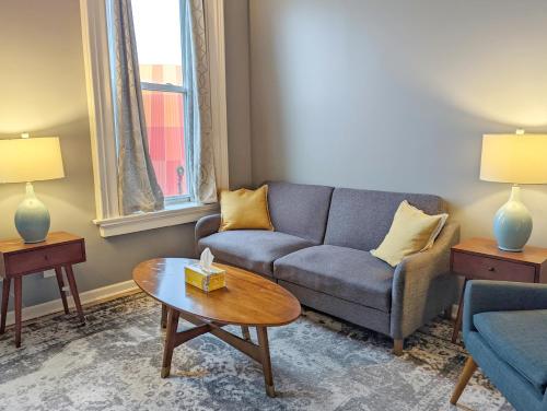 a living room with a couch and a table at Tanner Building in Bay City