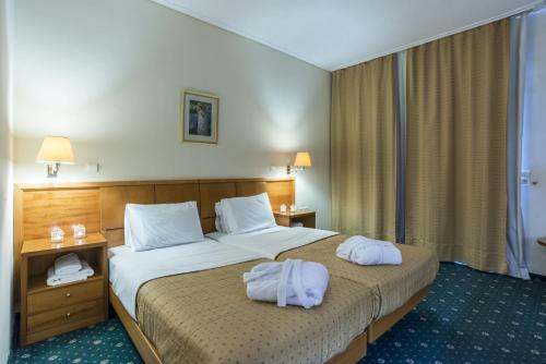 a hotel room with two towels on a bed at Hotel Philippos Livadeia in Livadeia