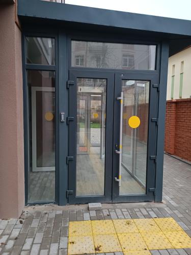 an open door of a building with glass at Apartments Domovik Миру 11с /11 in Mukacheve