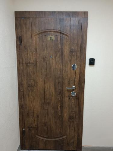 a wooden door in the corner of a room at Apartments Domovik Миру 11с /11 in Mukacheve
