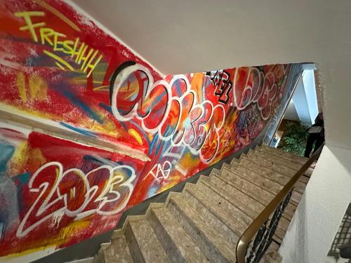 a staircase covered in graffiti with a skateboard on it at Mike‘s Mosel Lodge in Treis-Karden