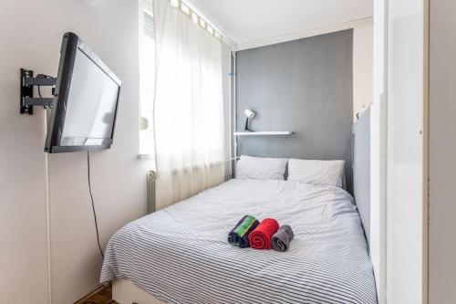 a bed with two slippers and a television on it at Lovely Studio with a big terrace in Belgrade
