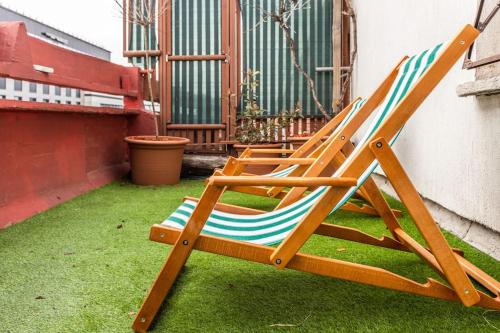 a couple of lawn chairs sitting on the grass at Lovely Studio with a big terrace in Belgrade