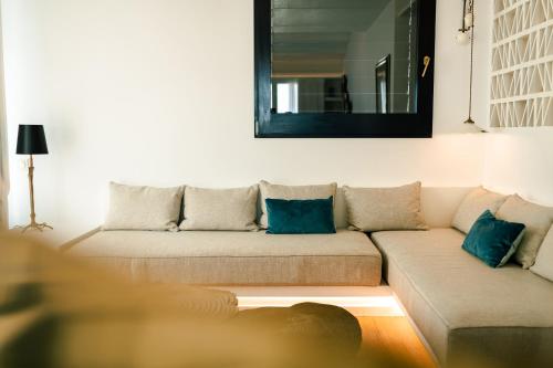 a living room with a couch with blue pillows at Boutique Hotel Villa Gala by Fimedhotels in Cadaqués