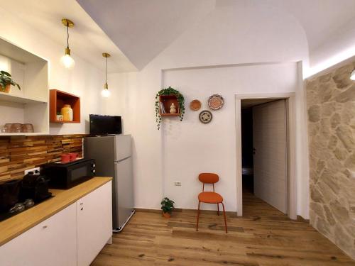 a kitchen with a chair and a refrigerator at Core Cagliari in Cagliari