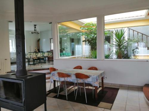 a dining room with a fireplace and a table and chairs at Casa do Trovador in Serra