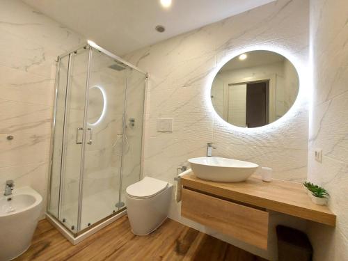 a bathroom with a sink toilet and a mirror at Core Cagliari in Cagliari