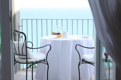 a white table and two chairs on a balcony at dimore di portadibasso in Peschici