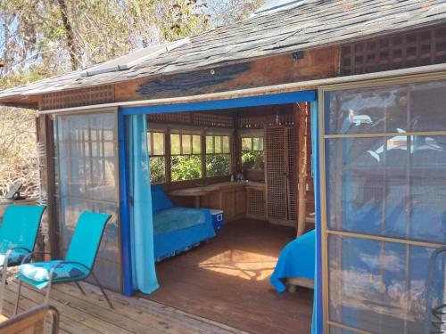 a gazebo with a bed and chairs on a deck at Beached Bungalow Overlooking the Pacific Ocean in Boca Chica