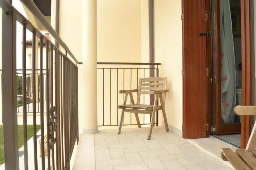 a chair sitting on the porch of a house at Apartment Terre Roveresche in San Giorgio di Pesaro