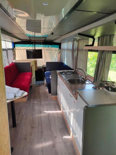 a kitchen and living room of an rv at terrebioBus in Visnadello