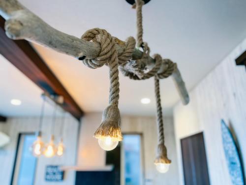 a rope chandelier with lights hanging from a ceiling at Ocean Villa Vihara ヴィハーラ in Ōda