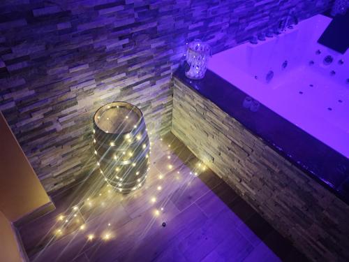 a bathroom with a tub and a glass vase with lights at COUNTRYSIDE SUITE in Ceprano