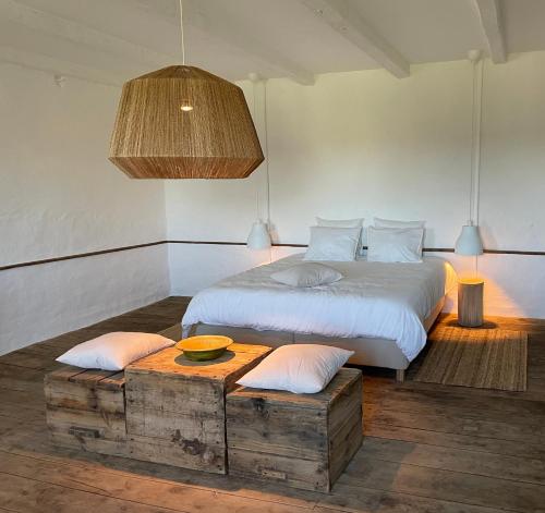 a bedroom with a bed and a table with pillows at Chateau de Cours in Sénezergues