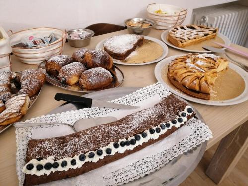 a table topped with different types of cakes and pastries at B&B Castello Cimbergo in Cimbergo