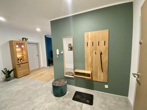 a room with two mirrors on a green wall at BR12 Premium Apartments , garaż in Bielsko-Biala
