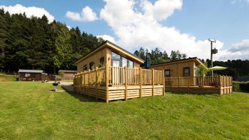 a small cabin in a field of grass at Tayview Lodges in Pitlochry