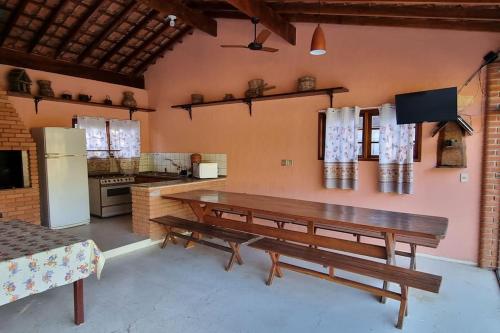 kuchnia z drewnianym stołem i lodówką w obiekcie Sítio das Águas w mieście Bom Jesus dos Perdões