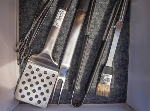 a box with various kitchen utensils and a brush at Escape 4BR Penthouse Close to Blue Mall with Private Outdoor Rooftop Terrace in Santo Domingo