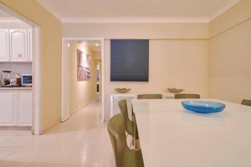 a kitchen with a table with a blue bowl on it at Escape 4BR Penthouse Close to Blue Mall with Private Outdoor Rooftop Terrace in Santo Domingo