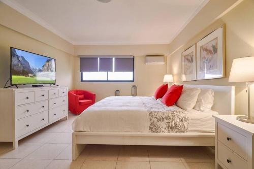 a bedroom with a large bed and a flat screen tv at Escape 4BR Penthouse Close to Blue Mall with Private Outdoor Rooftop Terrace in Santo Domingo