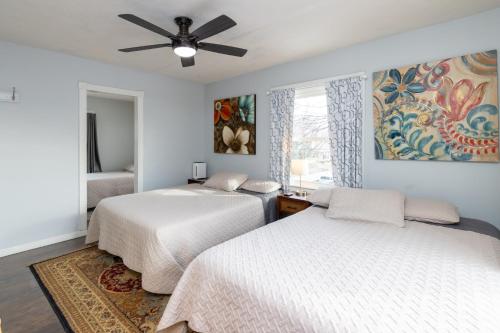 a bedroom with two beds and a ceiling fan at 5 Bedroom 3200 Square Foot House for Downtown Travelers in Indianapolis