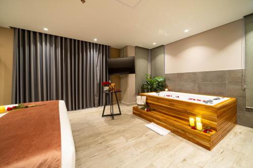 a room with a pool table in the middle of it at Eutopiq Hotel in Medellín