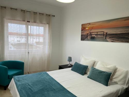 a bedroom with a bed and a large window at Confort Apartment 2 Bedrooms in Alhos Vedros