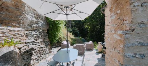 a table and chairs under an umbrella on a patio at U Vechju Mulinu in Ortiporio