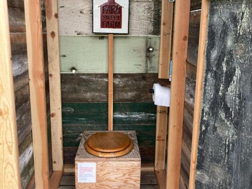 a wooden toilet sitting on a box in a room at Tentrr Signature - Hidden Acres Orchards in Mead