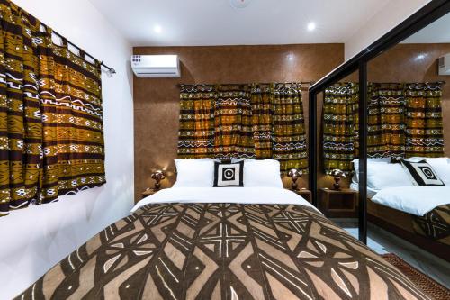a bedroom with two beds in a room at ChezBabo Wellness Hotel in Ngaparou