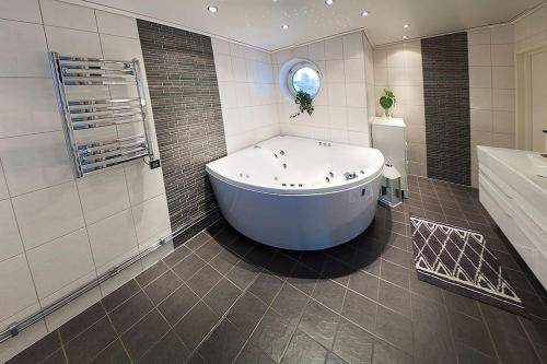a large bathroom with a tub and a shower at Exclusive villa Stockholm in Stockholm