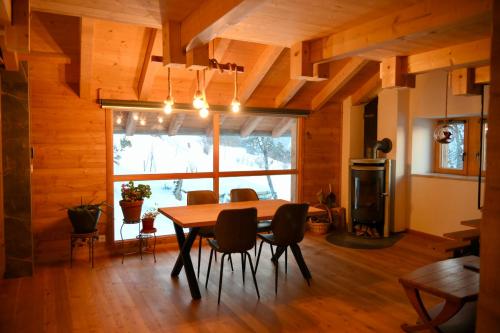 a dining room with a table and chairs at Consulat des Elohim chez Allan et Lili-Peace in Crans-Montana
