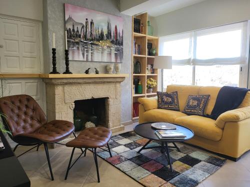 a living room with a couch and a fireplace at Apartaments Font del Cirerer in Sant Hilari Sacalm