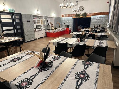 a dining room with tables and chairs in a restaurant at WRZOS resort & wellness in Węgierska Górka
